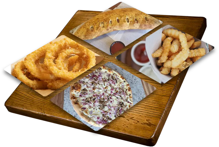A wooden table topped with pizza and fries.